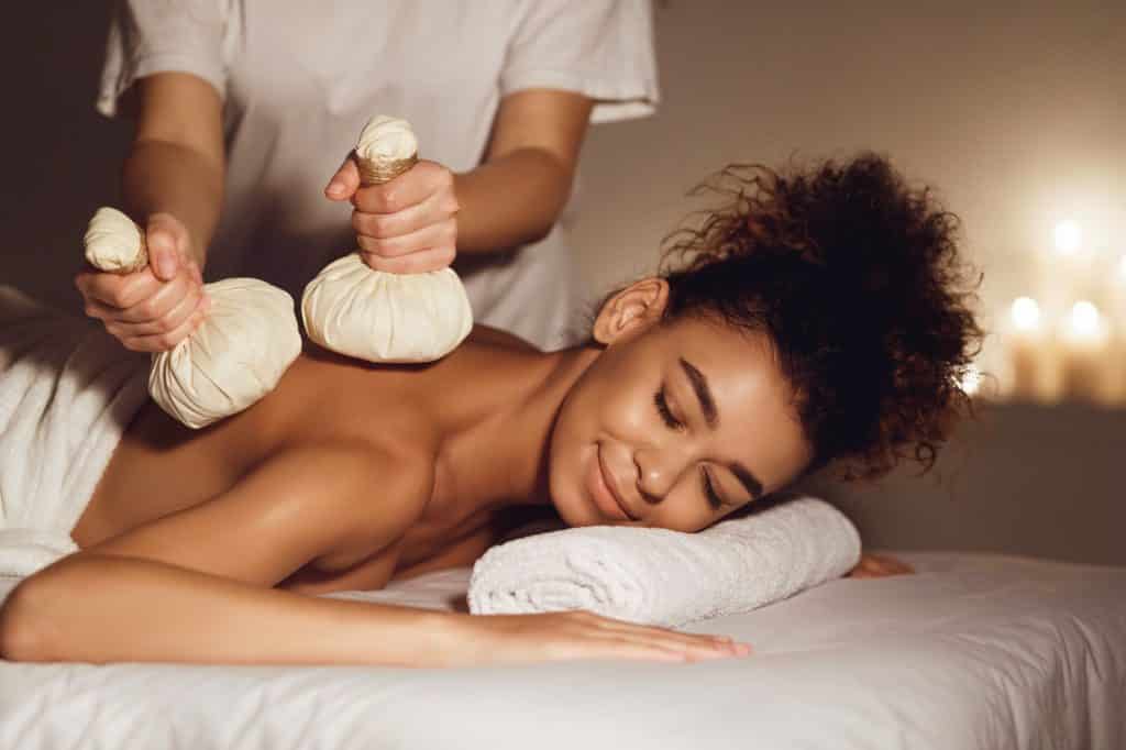 Body care. Massage with hot herbal balls for deep relaxation