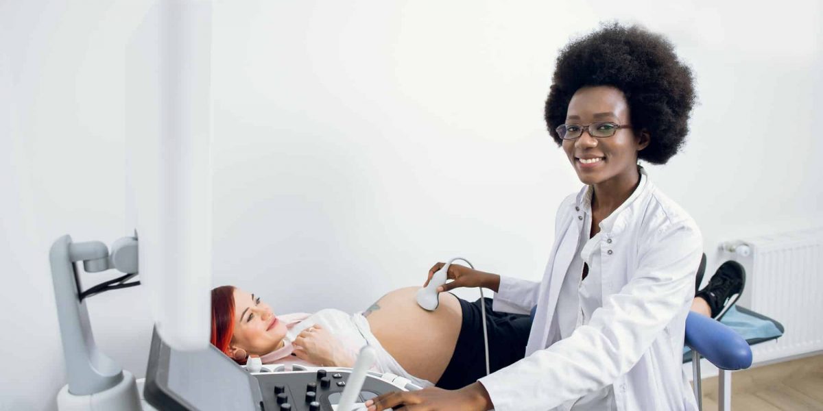 Medicine, healthcare and ultrasound concept. Pregnancy and obstetrics. Happy satisfied afro-american